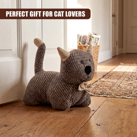 Stuffed kitten toy, knitted in gray yarn, featuring a bow and upright tail.