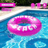 Pink inflatable ring with white lettering, floating in a blue swimming pool.
