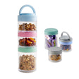 Stackable snack storage pots and two smaller round containers holding various dried nuts and fruits.