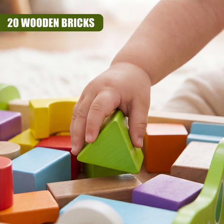 A hand selects a bright green wooden triangular block near other colorful wooden blocks.