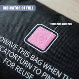 Black fabric dehumidifier bag showing a visible pink indicator patch that changes color when full.