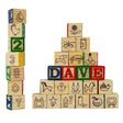 Stack of wooden blocks showing numbers, letters, and various themed pictograms like animals and objects.