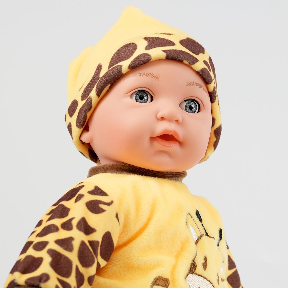 A doll dressed in cheetah print outfit.