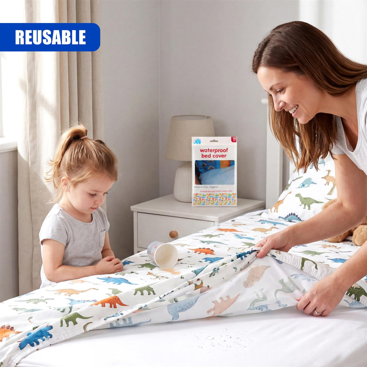 Dinosaur patterned bed cover is spread on a bed, being handled by a child and adult.