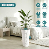 White, fluted cylindrical flower pot displayed with dimensions in a styled bedroom setting.