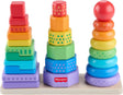 Three sets of wooden stacking toys: solid blocks, patterned cubes, and colored nested rings.