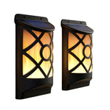 Pair of black, lantern-style wall sconces with visible grilles and warm internal light.