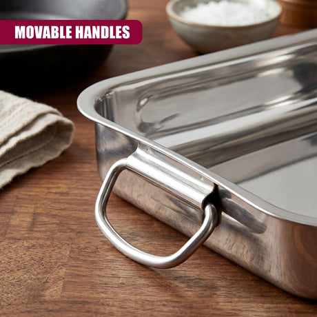 Rectangular stainless steel roasting tray featuring a sturdy integrated metal handle resting on wood.