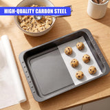 A rectangular dark gray metal roasting pan contains several baked cookies resting on white parchment paper.