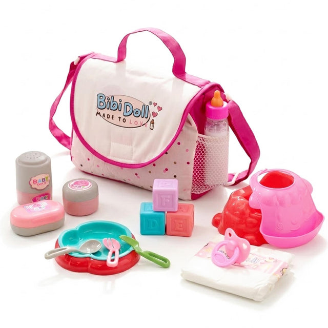 Pink doll changing bag accompanied by blocks, small bottles, red plastic toys, and cleaning accessories.