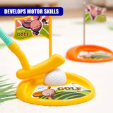 Yellow toy golf club rests on a green play mat near a white ball and plastic flag marker.