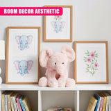 A collection of framed prints featuring a blue elephant with pink ears and a pink flower, displayed on a white wall with a plush pink elephant in the foreground. - UKBuyZone
