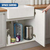 Open cabinet under the sink reveals a draining rack, various cleaning supplies, and a metal container.