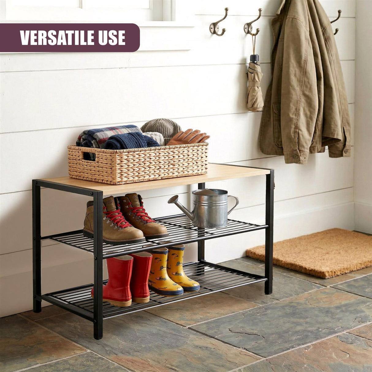 Black metal shoe rack with two tiers holding assorted footwear and a woven storage basket.