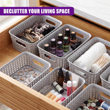White baskets contain dried herbs, small bottles, jewelry, and white wrapped craft supplies.