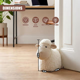 Plush white sheep door stopper shown standing next to a white door frame on hardwood flooring.