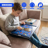 A boy sits on a couch using a rectangular, decorated blue lap tray with a space theme.