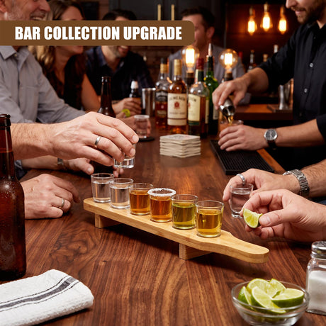 A set of six shot glasses on a wooden tray sits on a bar counter, surrounded by bottles and people drinking