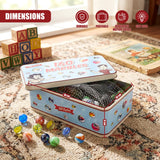 A blue and white marble tin box rests on a rug, surrounded by alphabet blocks and loose colored marbles.