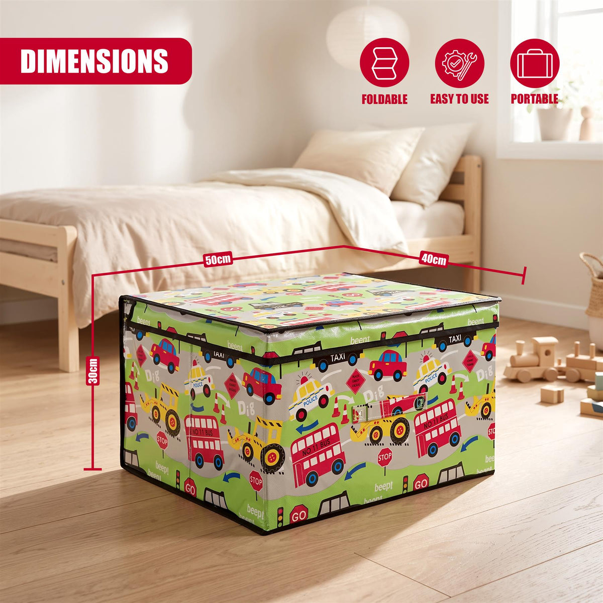 A green foldable storage box with a road-themed design featuring buses and tractors, shown on a wooden floor in a bedroom