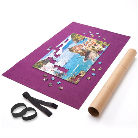 Purple puzzle mat, rolled tube, black strap, and blue puzzle pieces arranged for assembly.