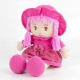 Rag doll Ruby sits wearing a pink hat and glittery pink dress. The doll has long pink yarn hair.