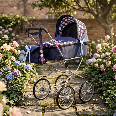 Blue doll pram with patterned fabric sits on cobblestones among blooming flowers.