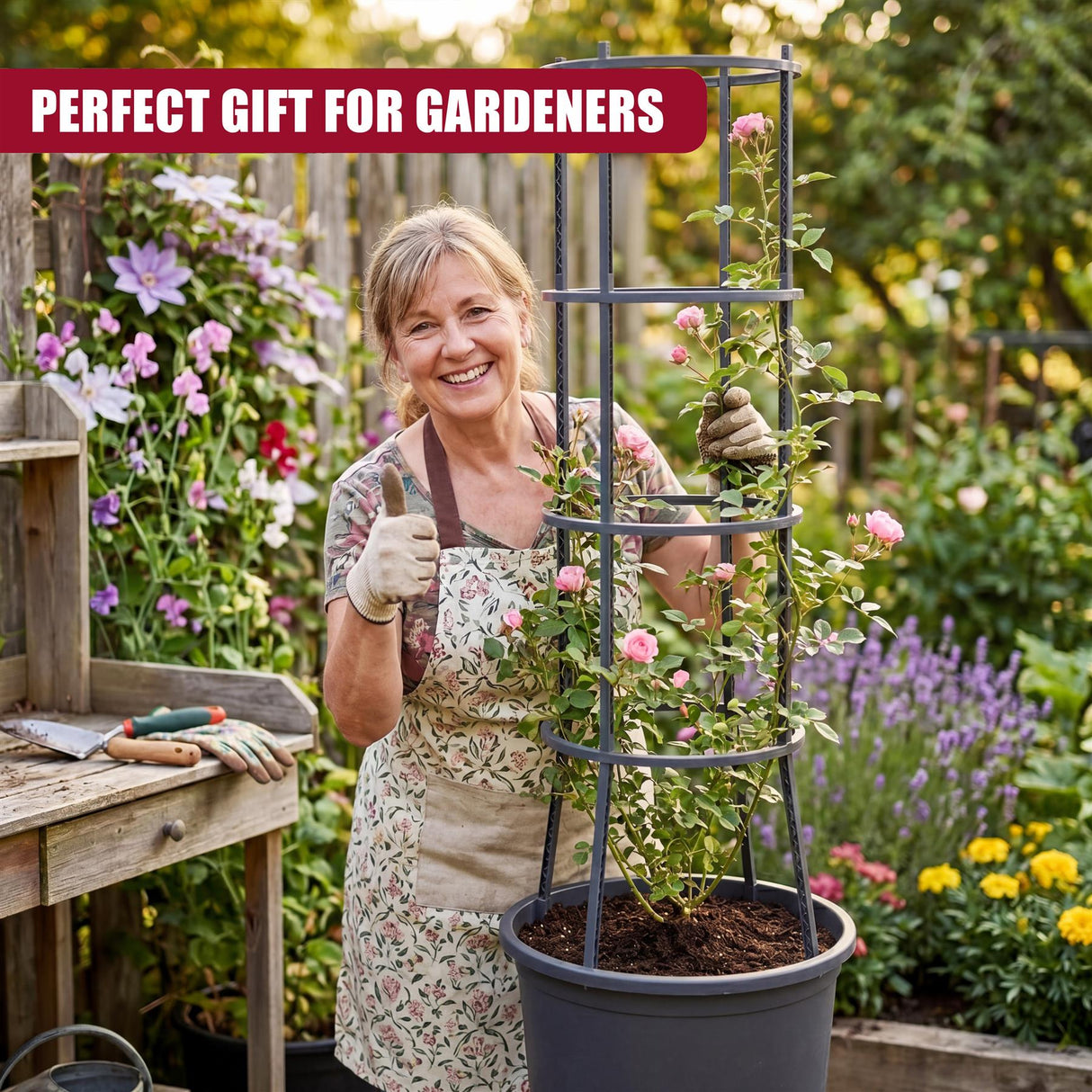 A gardener smiles with a black, four-tiered metal stand holding potted plants in a garden setting.