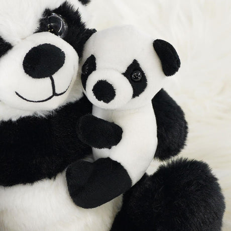 A super soft mommy panda plush toy holding a smaller baby panda, both with expressive eyes and cute features, set against a fluffy white background. Ideal for cuddling and playtime, perfect for children and collectors. Available at ukbuyzone.