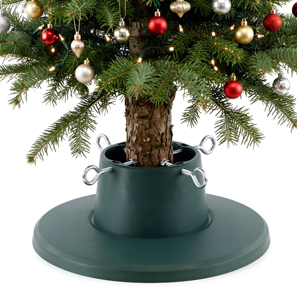 An adjustable green Christmas tree stand holding a decorated real tree