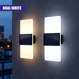 Dual wall sconces featuring vertical illuminated acrylic panels and integrated solar panel units.