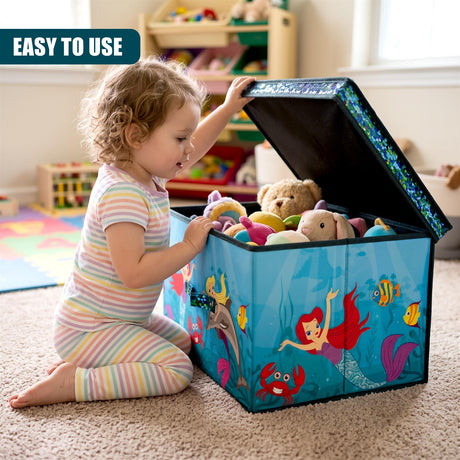 A young child in a striped outfit kneels on a carpet next to an open blue mermaid-themed storage box filled with toys