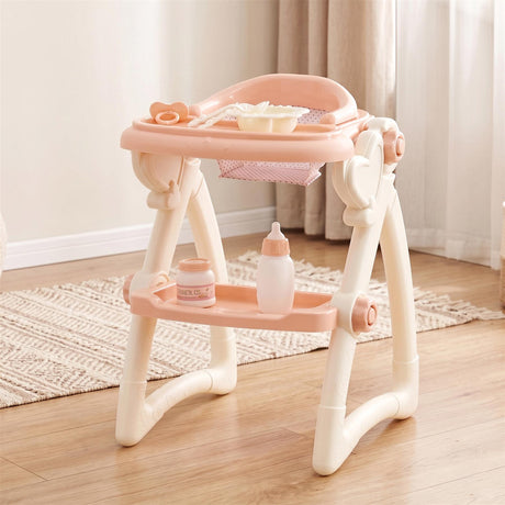Light pink doll high chair with a tray displays a baby bottle, snack dish, and coordinating accessory jars.