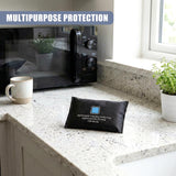 Black fabric bag with white text rests on a kitchen countertop in front of a toaster oven.