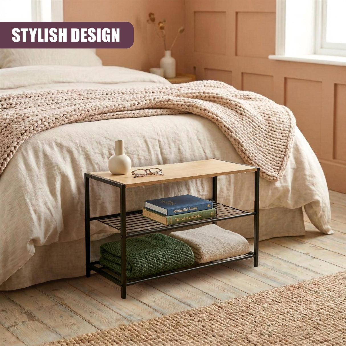 Black tiered shoe rack displaying stacked books, folded items, and small decorative pieces.