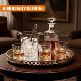 A set of four whiskey glasses, an ice bucket, and a liquor decanter resting on a decorative serving tray.