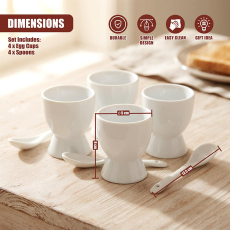 A set of four white ceramic egg cups and matching spoons arranged on a wooden surface