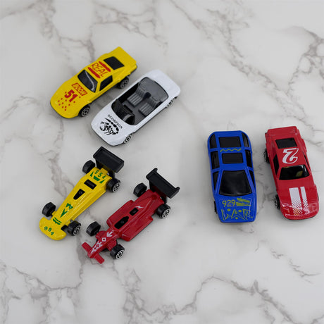 The image shows a collection of die cast racing cars in various colors, including red, yellow, white, and green.