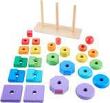 A set of wooden shapes and brightly colored geometric blocks, including squares, circles, and prisms.