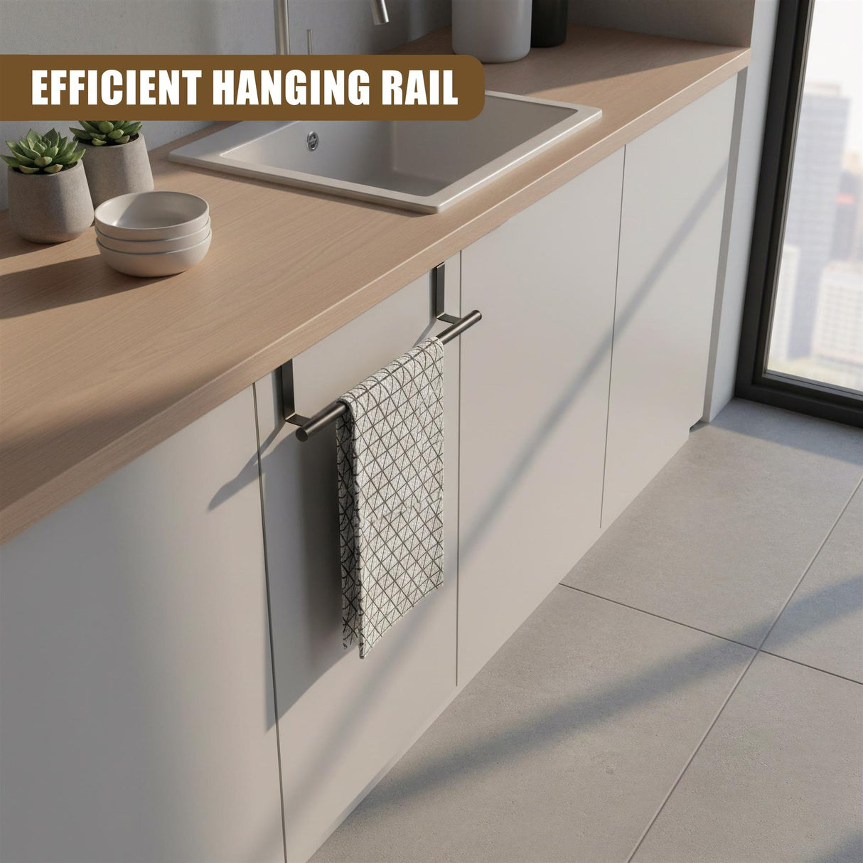 Metal towel rail installed on kitchen cabinetry, holding a patterned gray textile towel.