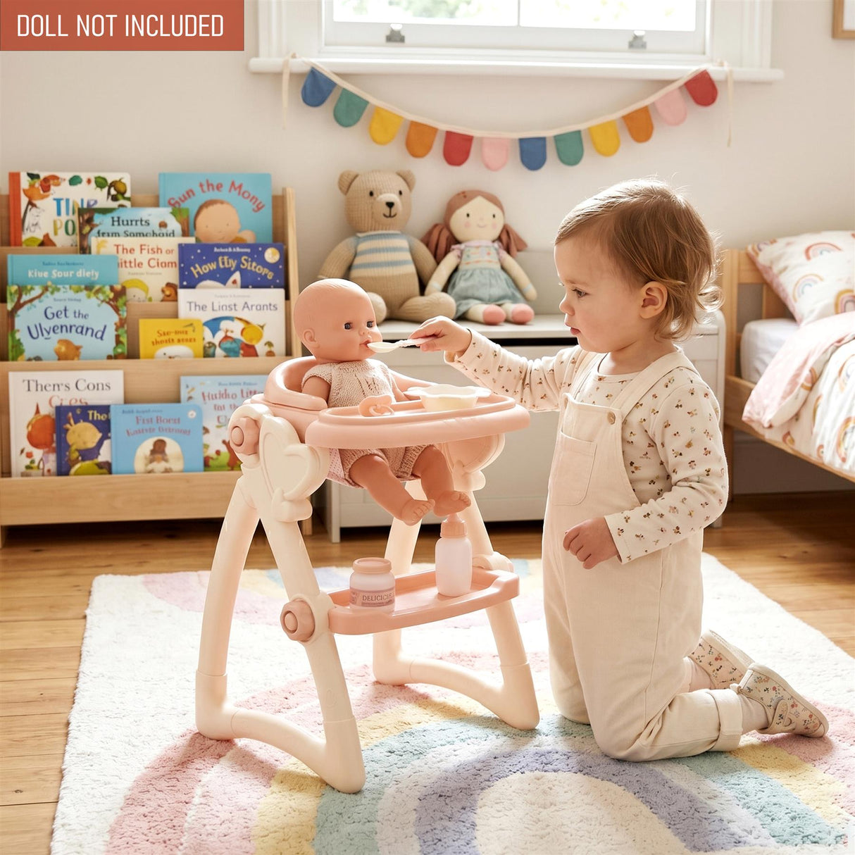 Child interacts with pink doll high chair and accessories, feeding a doll seated on the chair.