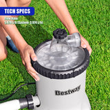 A cylindrical Bestway pool filter pump filled with clear filtration media, standing on green grass.