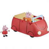 Red toy car wagon containing a figure, paired with a standing Peppa Pig plastic toy.