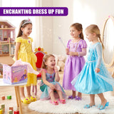 Girls in gowns play with dress-up accessories, shoes, and crowns in a brightly lit room.