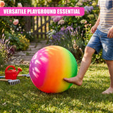 A person reaches toward a brightly colored rainbow ball resting on green grass.