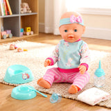 A baby doll is surrounded by blue and pink feeding accessories, including bottles and dishes.