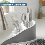 Countertop utensil holder containing forks, spoon, and knife rests on a drying rack.