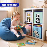 A toddler sitting on a bean bag chair, reading a book. There are three shelves filled with books and two more children's books in front of the child, one being a lift-the-flap book. The room has a white tiled floor and a cozy atmosphere. - UKBuyZone