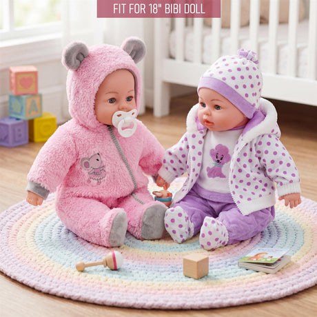 Two dolls, one in pink and one in purple, are posed on a rainbow rug with assorted toys and blocks.