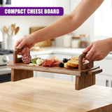 Various snacks, including cheese, cured meats, olives, and bread, are arranged on a rectangular wooden serving platter.
